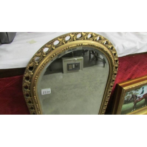 2334 - An arched top bevel edged mirror in gilt frame.  (Collect only)