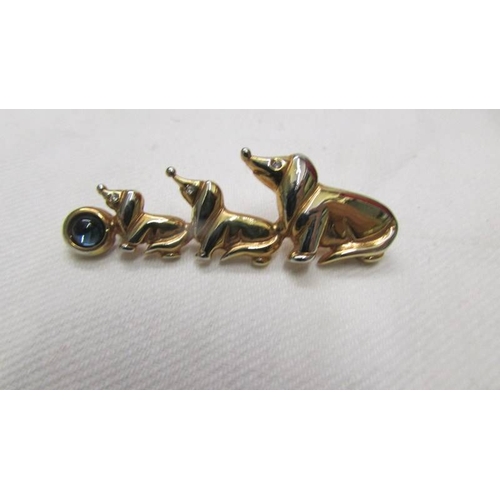 2080 - A White metal cat brooch and a yellow metal dachsund brooch.