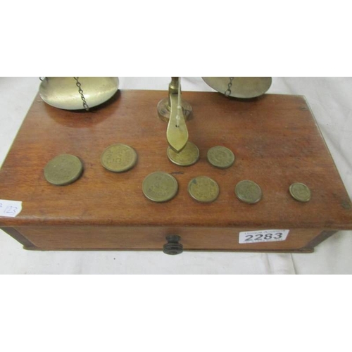 2283 - A set of brass postal scales on mahogany drawer base.