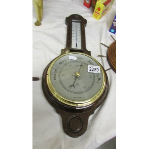 2289 - An oak barometer/thermometer in good condition together with another barometer (cracked glass)