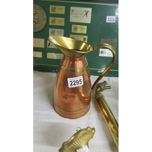 2295 - A brass garden spray, a wall light and a copper jug.