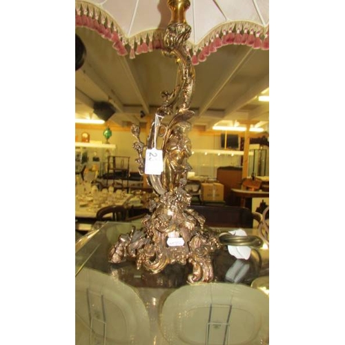 2356 - A heavy brass table lamp with cherub to base and with good quality fringed shade. (Collect only)