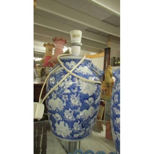 2381 - A pair of blue and white Chinese style table lamp bases (one with fittings, one without),  (Collect ... 