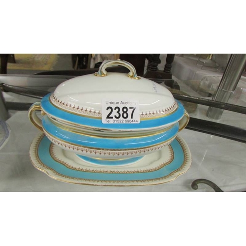 2387 - A Royal Worcester sauce tureen and a blue and white sauce tureen with ladle.