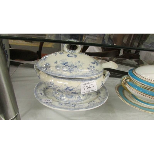 2387 - A Royal Worcester sauce tureen and a blue and white sauce tureen with ladle.