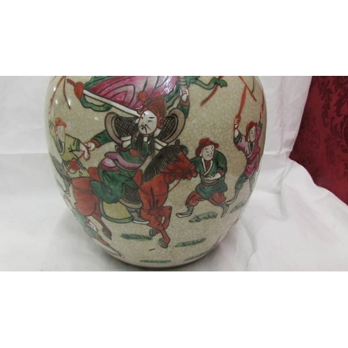 2102 - A Chinese/Japanese ginger jar depicting fighting figures. (Collect only)