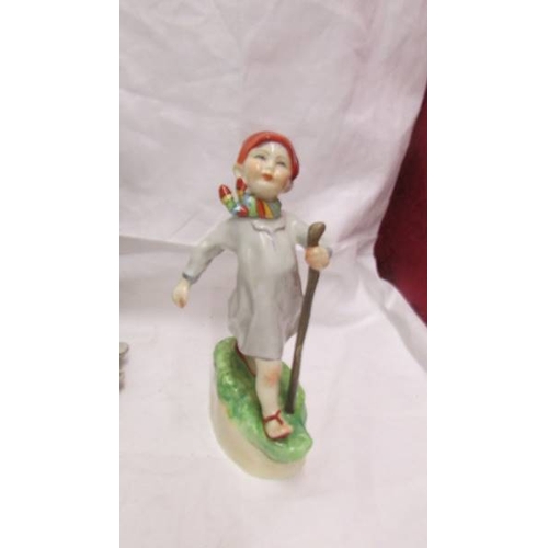 2106 - A figure of a girl with butterfly marked with a crown over the letter N, a Goeble boy figure and ano... 