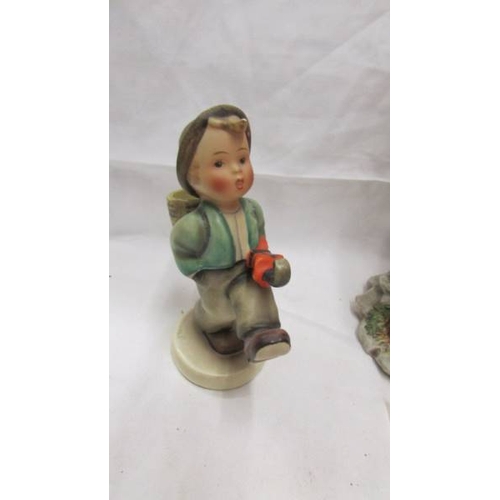 2106 - A figure of a girl with butterfly marked with a crown over the letter N, a Goeble boy figure and ano... 