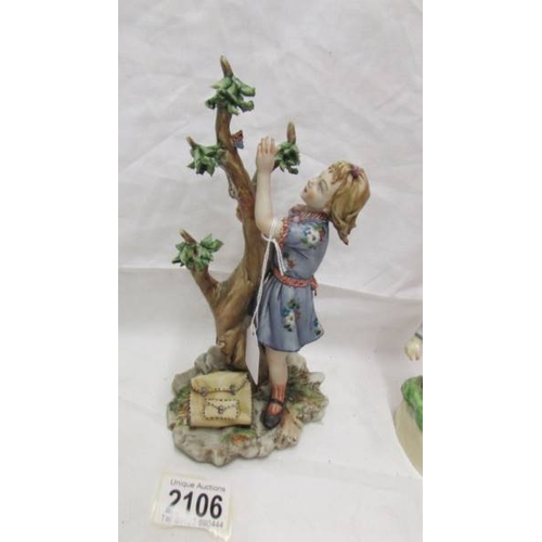 2106 - A figure of a girl with butterfly marked with a crown over the letter N, a Goeble boy figure and ano... 