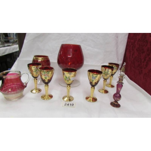 2410 - A set of 6 Bohemian gold decorated glasses and other red glass.