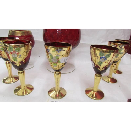 2410 - A set of 6 Bohemian gold decorated glasses and other red glass.