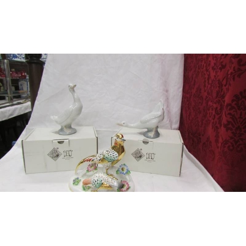 2411 - A hand painted golden pheasant group and two boxed NAO ducks.