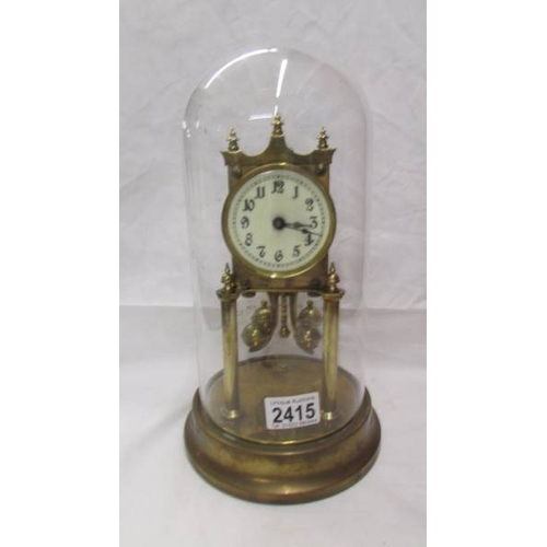 2415 - A 1910 Badisch Uhren Fabrik anniversary clock under glass dome, complete with key.  (Collect only)