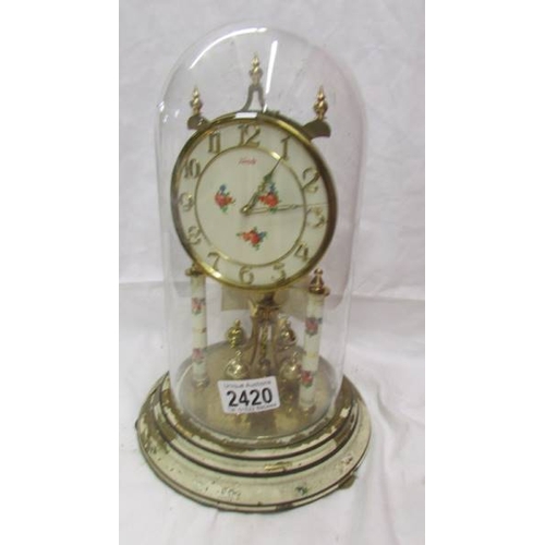 2420 - A Kundo anniversary clock under glass dome, needs new feather. (Collect only)