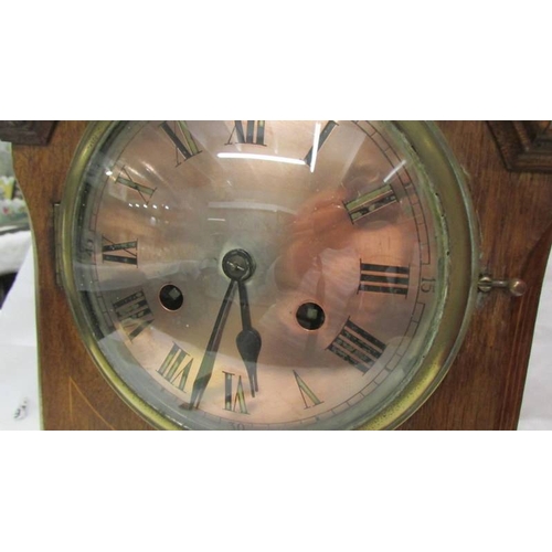 2427 - A mahogany inlaid 8 day mantel clock. (Collect only)