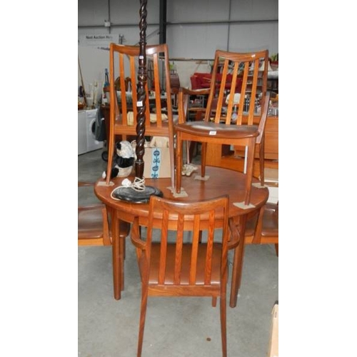 122 - A teak dining table and four chairs. (collect only)