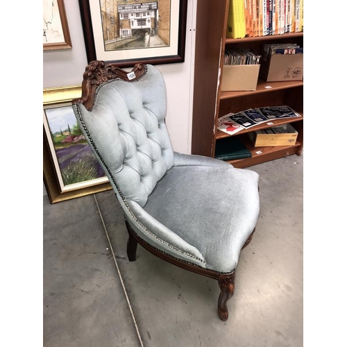 1528 - A Victorian style deep buttoned shield back nursing chair with carved mahogany frame