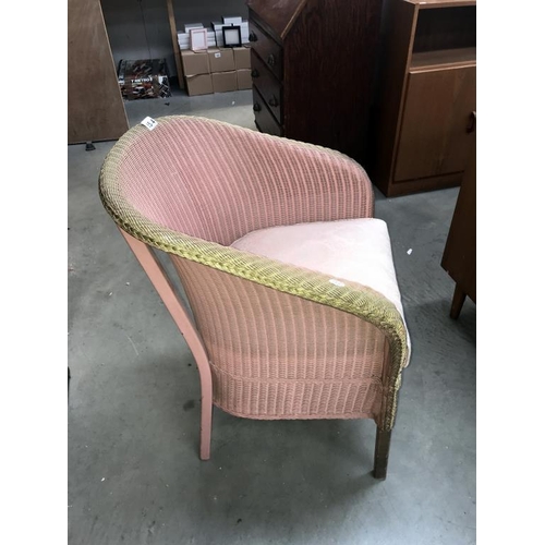 1544 - A pink Lloyd Loom chair with storage compartment