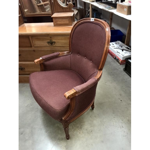 1557 - A mahogany framed balloon back armchair with burgundy upholstery