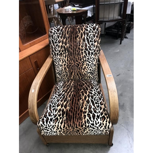 1560 - A 1930's oak framed armchair with later leopard print upholstery