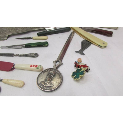 2121 - A mixed lot including metal cigarette box, a cut throat razor, a paperknife, various knives, scissor... 