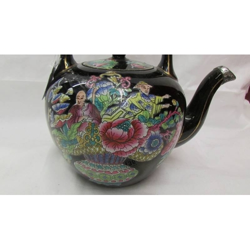 2136 - A Chinese hand painted tea pot.