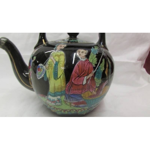 2136 - A Chinese hand painted tea pot.