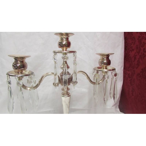 2139 - A silver plate candelabra with crystal droppers.