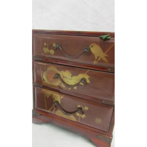 2143 - A miniature lacquered three drawer chest and a lacquered box.