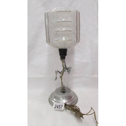 2457 - An art deco chrome figurine table lamp complete with shade.