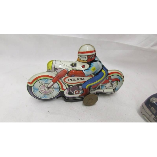 2462 - A tinplate Mettoy police car and Western Germany and Spanish motor cycles.