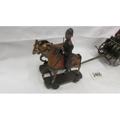 2466 - A pre-war tin plate military carriage with hard plastic figures and horses, no visible makers marks.