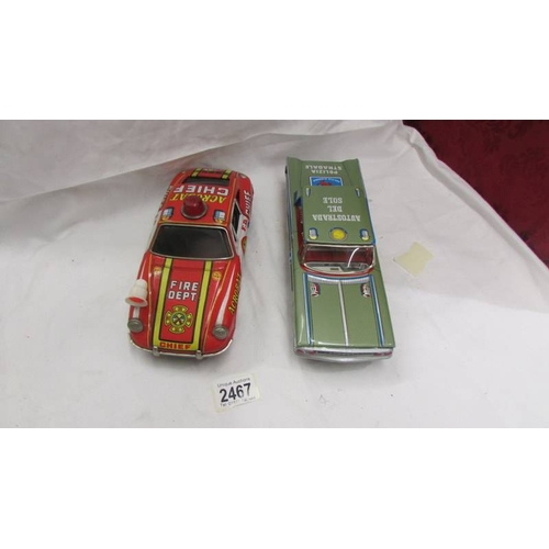 2467 - A Japanese tin plate battery operated Porsche 911 fire dept., and Italian tin plate clockwork police... 