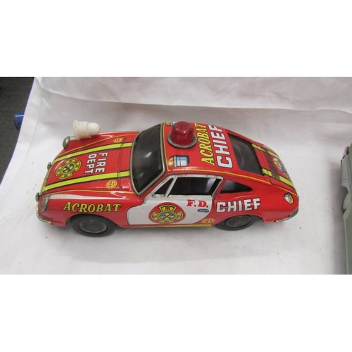 2467 - A Japanese tin plate battery operated Porsche 911 fire dept., and Italian tin plate clockwork police... 