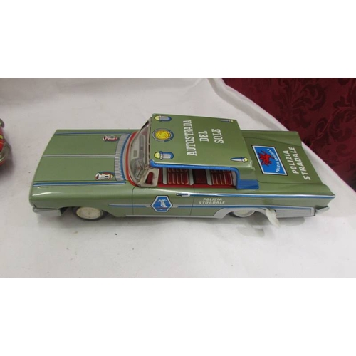 2467 - A Japanese tin plate battery operated Porsche 911 fire dept., and Italian tin plate clockwork police... 