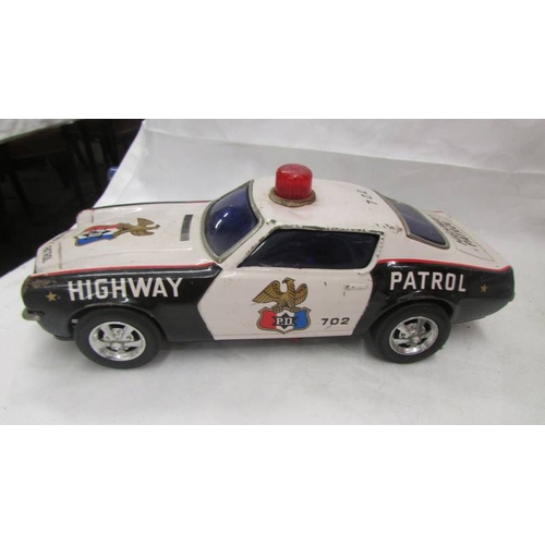 2468 - Two large tin plate battery operated American police cars - Trans-Am and Tornado.