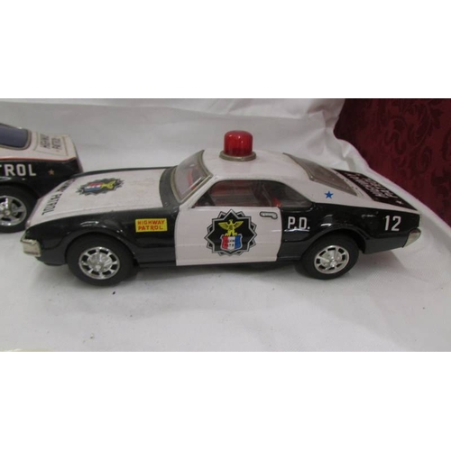 2468 - Two large tin plate battery operated American police cars - Trans-Am and Tornado.