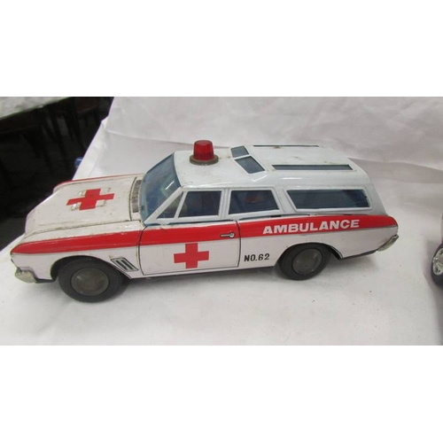 2469 - A large Japanese A1 HSAKUSA tinplate battery operated Buick ambulance and an un-named police Ford Mu... 