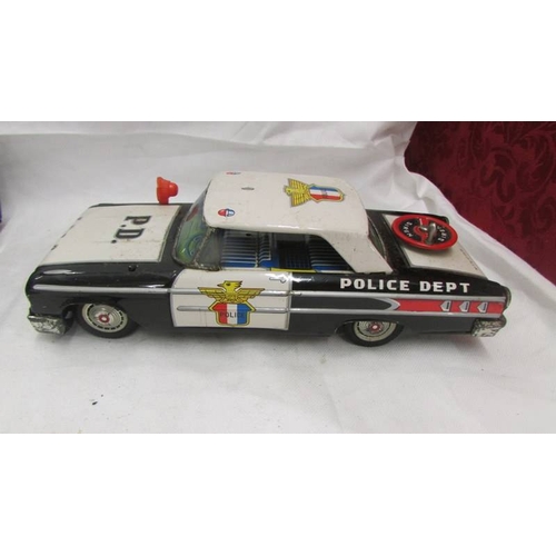 2470 - An 'ASC' Japan tinplate friction police car with siren, a Japanese police van and an un-named Bedfor... 