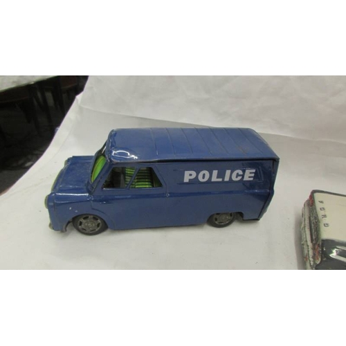 2470 - An 'ASC' Japan tinplate friction police car with siren, a Japanese police van and an un-named Bedfor... 