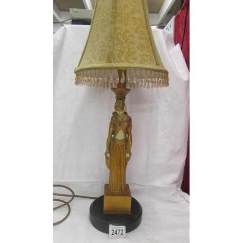 2472 - An art deco style figural table lamp with shade.