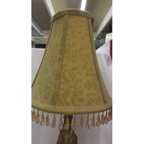 2472 - An art deco style figural table lamp with shade.