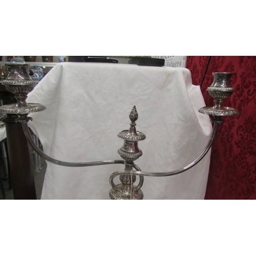 2473 - A large silver plate candelabra.