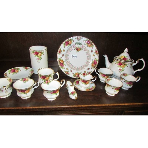 2498 - Six Royal Albert old country roses tea cups, a teapot, a coffee cup with saucers, utensil jar etc.,