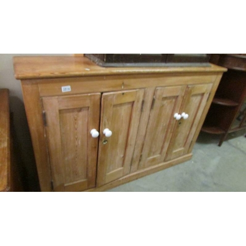 2514 - A pine four door cupboard. (collect only)