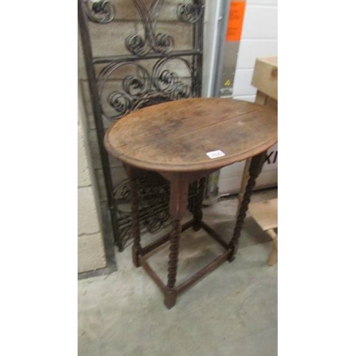 2526 - An oval oak occasional table on barley twist supports. (collect only)