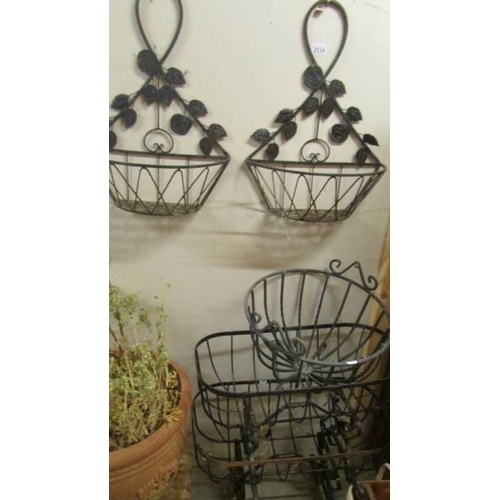 2534 - Three wrought iron garden baskets and 2 wall hanging baskets. (collect only)