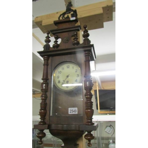 2549 - A small Victorian wall clock with key. (collect only)