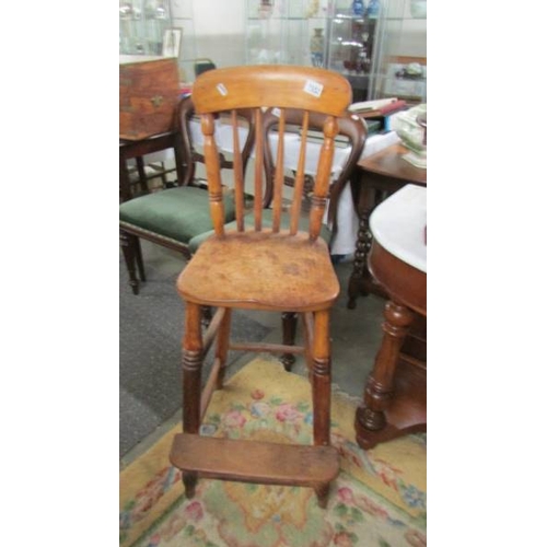 2552 - An early child's high chair with foot rest. (collect only)