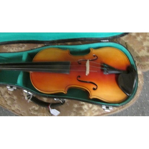 2568 - A cased three quarter size violin.